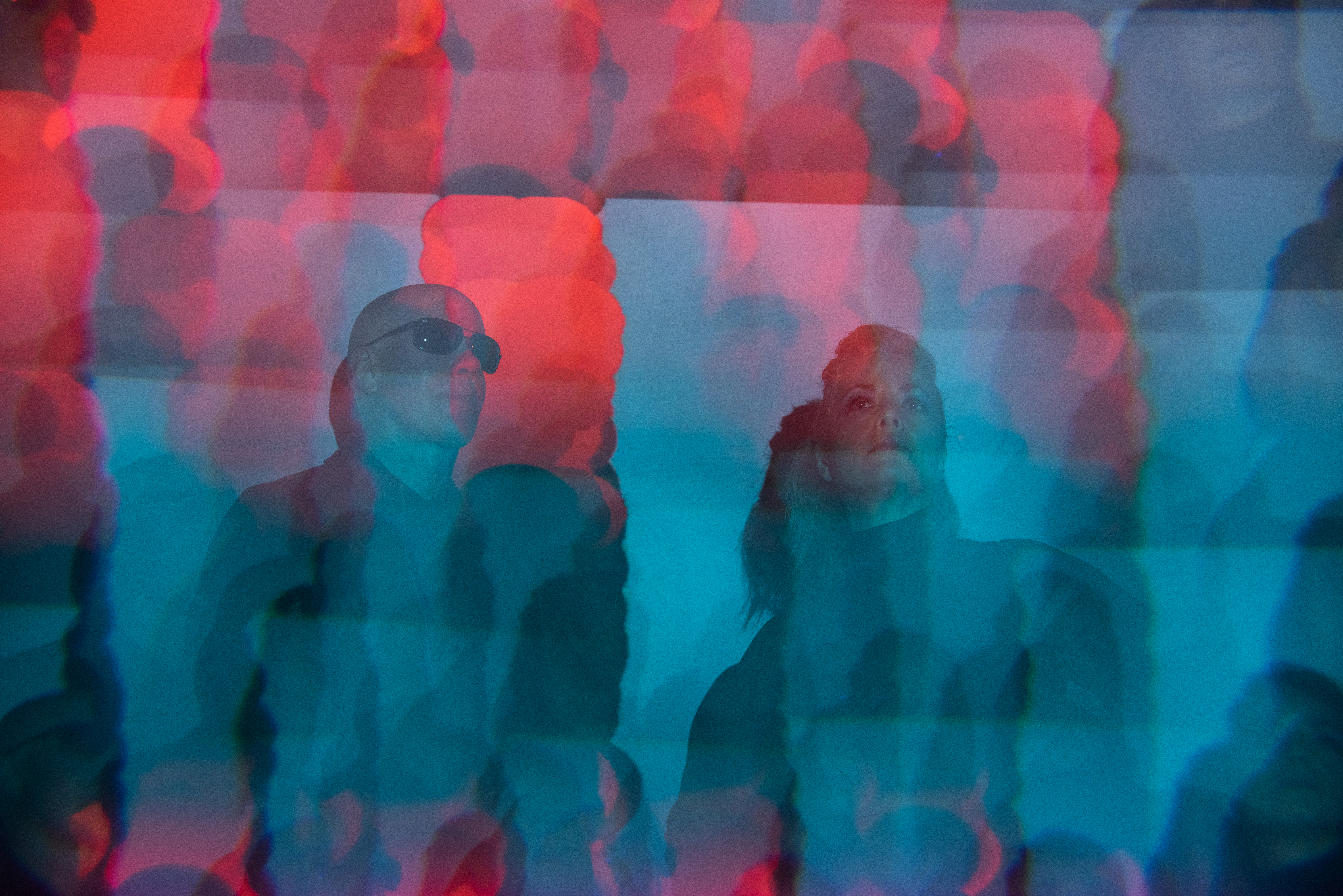 Reaper On Red by photographer Nikita Gross. The rock duo Reaper On Red featuring Robert Cherry and Carla Cherry. The ghostly red and blue photo was taken by photographer Nikita Gross.